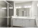 Bright bathroom featuring a double vanity with sleek white cabinetry and a glass-enclosed shower with subway tile surround at 1286 Brookins Trl, Atlanta, GA 30316