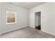 Unfurnished bedroom with soft carpet, a window, and doorway, offering ample space at 1286 Brookins Trl, Atlanta, GA 30316