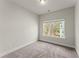 Neutral bedroom with soft carpet, natural light streaming through window, and freshly painted walls at 1286 Brookins Trl, Atlanta, GA 30316