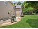 Beautiful backyard showcasing a lush lawn, patio with a grill, and a well-maintained home exterior at 2115 Brook Pond Ct, Alpharetta, GA 30005