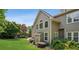 Landscaped backyard featuring a lush lawn, well-placed shrubbery, and multi-paned windows at 2115 Brook Pond Ct, Alpharetta, GA 30005