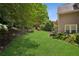 Beautiful backyard featuring lush green lawn and mature landscaping, perfect for outdoor living at 2115 Brook Pond Ct, Alpharetta, GA 30005