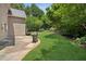 Well-manicured backyard with lush lawn and a patio with a grill at 2115 Brook Pond Ct, Alpharetta, GA 30005