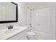 Clean bathroom with a tub-shower combo, single sink vanity, and a large mirror at 2115 Brook Pond Ct, Alpharetta, GA 30005