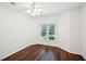 A simply decorated, yet bright bedroom with hardwood floors and a view to the backyard at 2115 Brook Pond Ct, Alpharetta, GA 30005