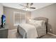 Cozy bedroom features a comfortable bed and a ceiling fan for added comfort at 2115 Brook Pond Ct, Alpharetta, GA 30005