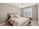 Relaxing bedroom with neutral tones, soft carpet, and a window letting in natural light at 2115 Brook Pond Ct, Alpharetta, GA 30005