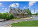 Charming community building featuring a stone facade, well-manicured landscaping, and covered porch at 2115 Brook Pond Ct, Alpharetta, GA 30005