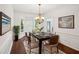 Bright dining room features a modern chandelier and bay window with wood flooring and a large decorative rug at 2115 Brook Pond Ct, Alpharetta, GA 30005
