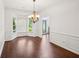 Bright dining room featuring hardwood floors, bay windows, wainscoting and a chandelier at 2115 Brook Pond Ct, Alpharetta, GA 30005