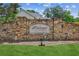 Stone sign reads 'Brookwood Lake' with manicured lawn and a glimpse of a house behind at 2115 Brook Pond Ct, Alpharetta, GA 30005