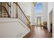 Bright, two-story foyer featuring hardwood floors, staircase with iron spindles, and large arched window at 2115 Brook Pond Ct, Alpharetta, GA 30005