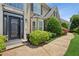 Inviting front entrance featuring manicured landscaping, a walkway and a decorative front door at 2115 Brook Pond Ct, Alpharetta, GA 30005