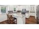 Bright kitchen features stainless steel appliances, granite countertops, a kitchen island and a dark backsplash at 2115 Brook Pond Ct, Alpharetta, GA 30005
