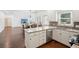 Spacious kitchen with white cabinets, granite countertops, and stainless steel appliances with an open floorplan at 2115 Brook Pond Ct, Alpharetta, GA 30005