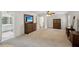 Spacious main bedroom with carpet and wooden furniture, leading into the main bathroom at 2115 Brook Pond Ct, Alpharetta, GA 30005