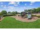 A fun playground with slides and climbing structures, surrounded by lush green grass at 2115 Brook Pond Ct, Alpharetta, GA 30005