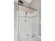 Close up of a modern shower with marble tiles and glass doors in the main bathroom at 2115 Brook Pond Ct, Alpharetta, GA 30005