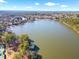 Aerial view of the lake near the tennis courts and surrounding community at 1102 White Cloud Rdg, Snellville, GA 30078