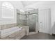 Bathroom featuring a large walk-in shower and soaking tub at 1102 White Cloud Rdg, Snellville, GA 30078