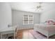Bright bedroom with a window, hardwood floors, desk, and a cozy bed at 1102 White Cloud Rdg, Snellville, GA 30078