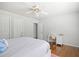 Bedroom with hardwood floors, white walls, ceiling fan, and desk space at 1102 White Cloud Rdg, Snellville, GA 30078