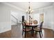 Bright dining room with hardwood floors, chandelier, and large window at 1102 White Cloud Rdg, Snellville, GA 30078