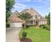 Charming two-story brick home with manicured lawn and attached two-car garage at 1102 White Cloud Rdg, Snellville, GA 30078