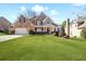 Charming two-story brick home with manicured lawn and inviting front porch at 1102 White Cloud Rdg, Snellville, GA 30078