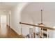 Hallway with hardwood floors, white railing, and an open view of the living room below at 1102 White Cloud Rdg, Snellville, GA 30078