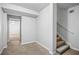 Hallway with neutral carpet, white walls, leading to stairs and other rooms at 1102 White Cloud Rdg, Snellville, GA 30078