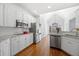 Modern kitchen with white cabinets, stainless steel appliances, and granite countertops at 1102 White Cloud Rdg, Snellville, GA 30078