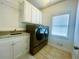 Convenient laundry room featuring granite countertops and modern washer and dryer at 1102 White Cloud Rdg, Snellville, GA 30078