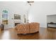 Spacious living room with fireplace, hardwood floors and elegant seating at 1102 White Cloud Rdg, Snellville, GA 30078