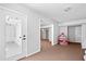 Spacious room with neutral carpet, white walls, and a doorway leading outside at 1102 White Cloud Rdg, Snellville, GA 30078