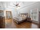 Cozy main bedroom features tray ceilings, natural light, and hardwood floors at 1102 White Cloud Rdg, Snellville, GA 30078