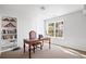 Bright office space featuring a traditional wooden desk, built-in shelving and a window providing natural light at 1102 White Cloud Rdg, Snellville, GA 30078