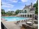 Community pool with lounge chairs and a clubhouse in the background at 1102 White Cloud Rdg, Snellville, GA 30078