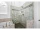 Bathroom with glass enclosed shower and natural stone tiling at 1102 White Cloud Rdg, Snellville, GA 30078