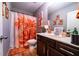 Bathroom with flower-patterned shower curtain, mirror, and vanity at 2376 Allman Dr, Jonesboro, GA 30236