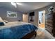 Spacious bedroom with a large bed, flat screen television, wood floors, and a decorative dresser at 2376 Allman Dr, Jonesboro, GA 30236