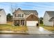 Two-story home with brick and tan siding, a two-car garage, and a well-maintained lawn at 2376 Allman Dr, Jonesboro, GA 30236