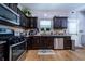 Contemporary kitchen with stainless steel appliances and wood-style flooring at 2376 Allman Dr, Jonesboro, GA 30236