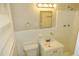 This bathroom features tile walls, a toilet and vanity with storage at 2630 Colonial Dr, College Park, GA 30337