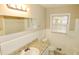 This bathroom features granite countertops, tile walls, and a large mirror at 2630 Colonial Dr, College Park, GA 30337
