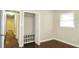 Comfortable bedroom with hardwood flooring, a closet with built-in shelving, and a window for natural light at 2630 Colonial Dr, College Park, GA 30337