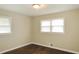 Cozy bedroom with two windows, hardwood floors, and neutral paint, creating a serene and comfortable space at 2630 Colonial Dr, College Park, GA 30337