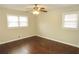 This bedroom features hardwood floors, a ceiling fan, and windows that bring in natural light at 2630 Colonial Dr, College Park, GA 30337