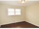 This bedroom features hardwood floors, and windows that bring in natural light at 2630 Colonial Dr, College Park, GA 30337
