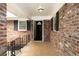 A brick front porch with railings and covered entry to home at 2630 Colonial Dr, College Park, GA 30337